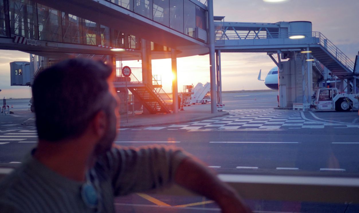 Man in Black and White Stripe Shirt Sitting on Bench