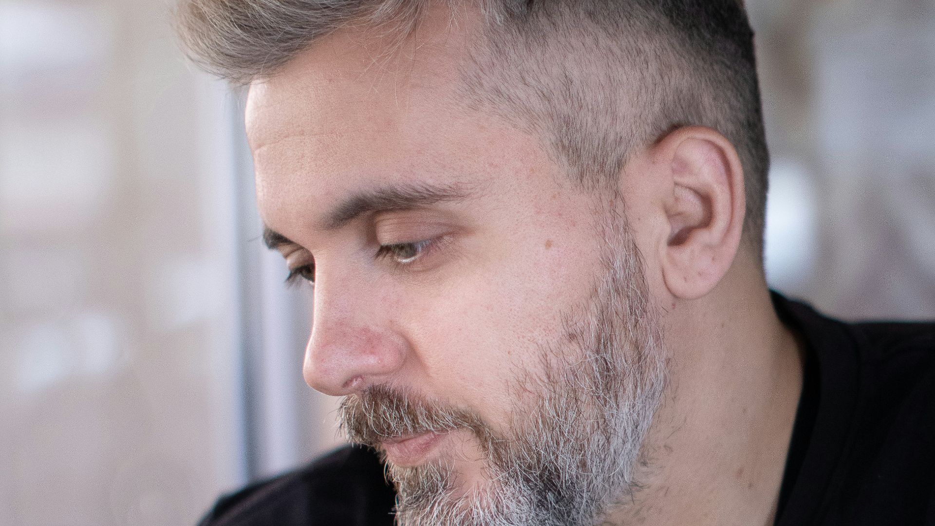 a man sitting at a table looking at his cell phone