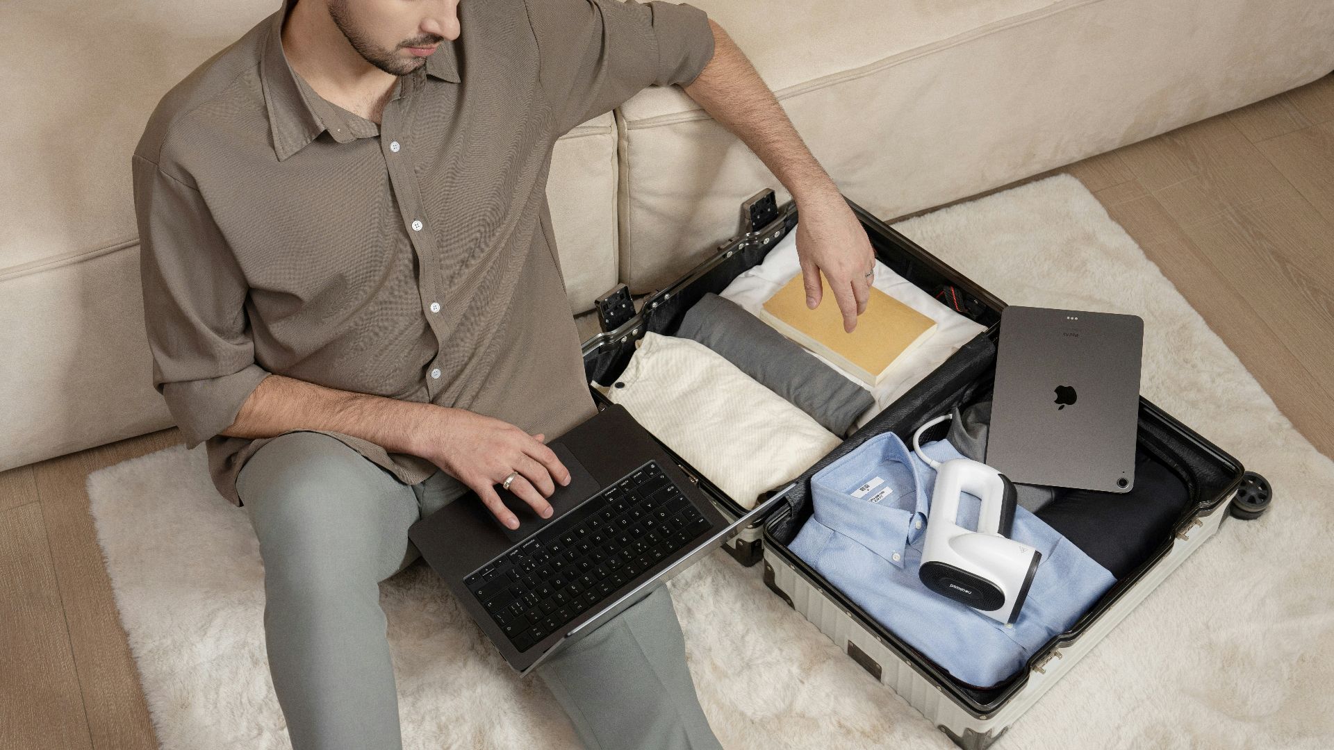 A man sitting on a couch using a laptop computer