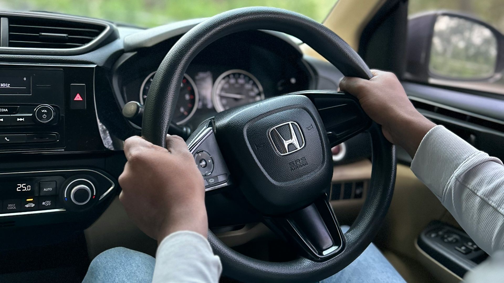 a person driving a car with a steering wheel