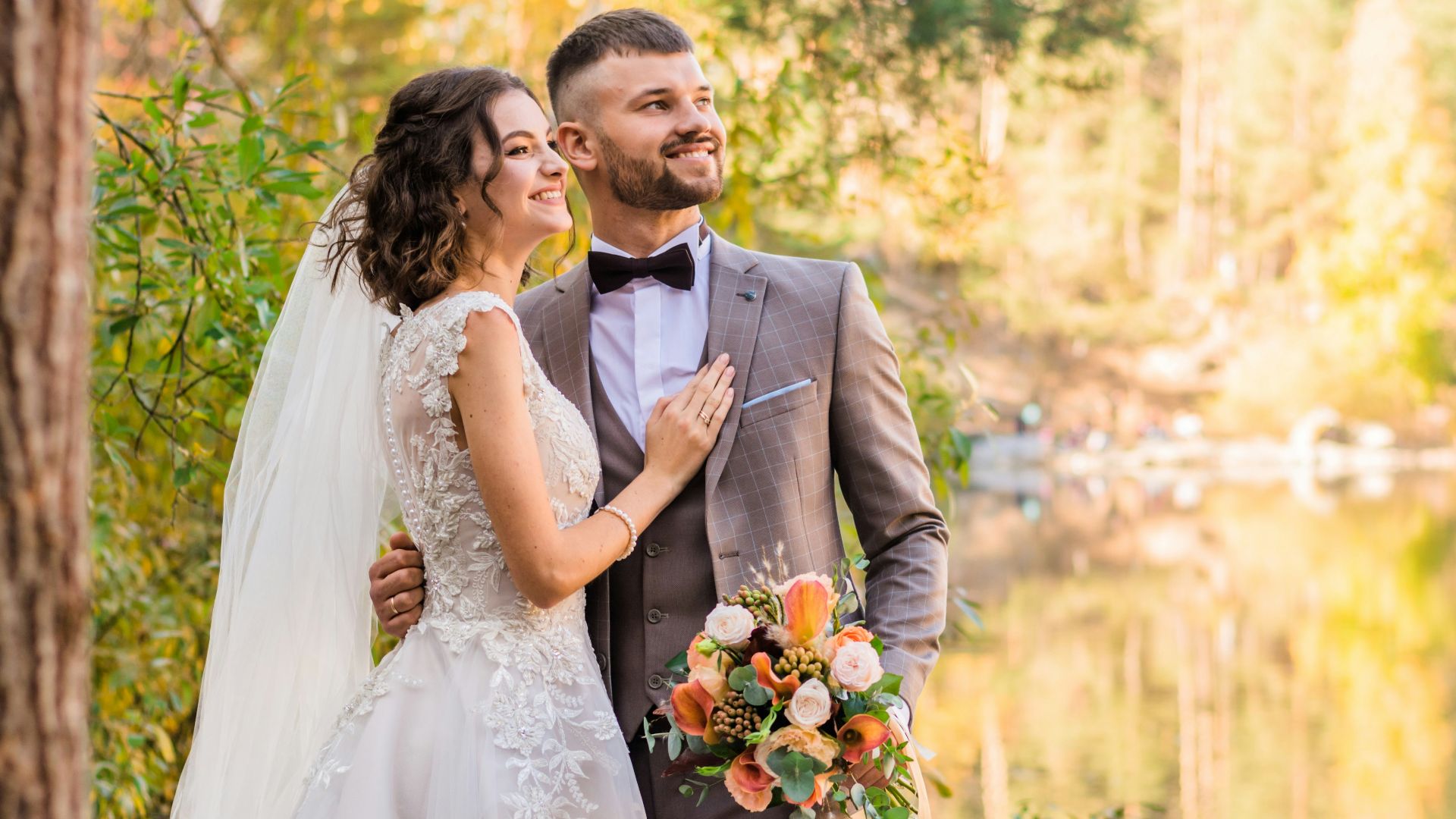 man in gray suit and woman in white wedding dress