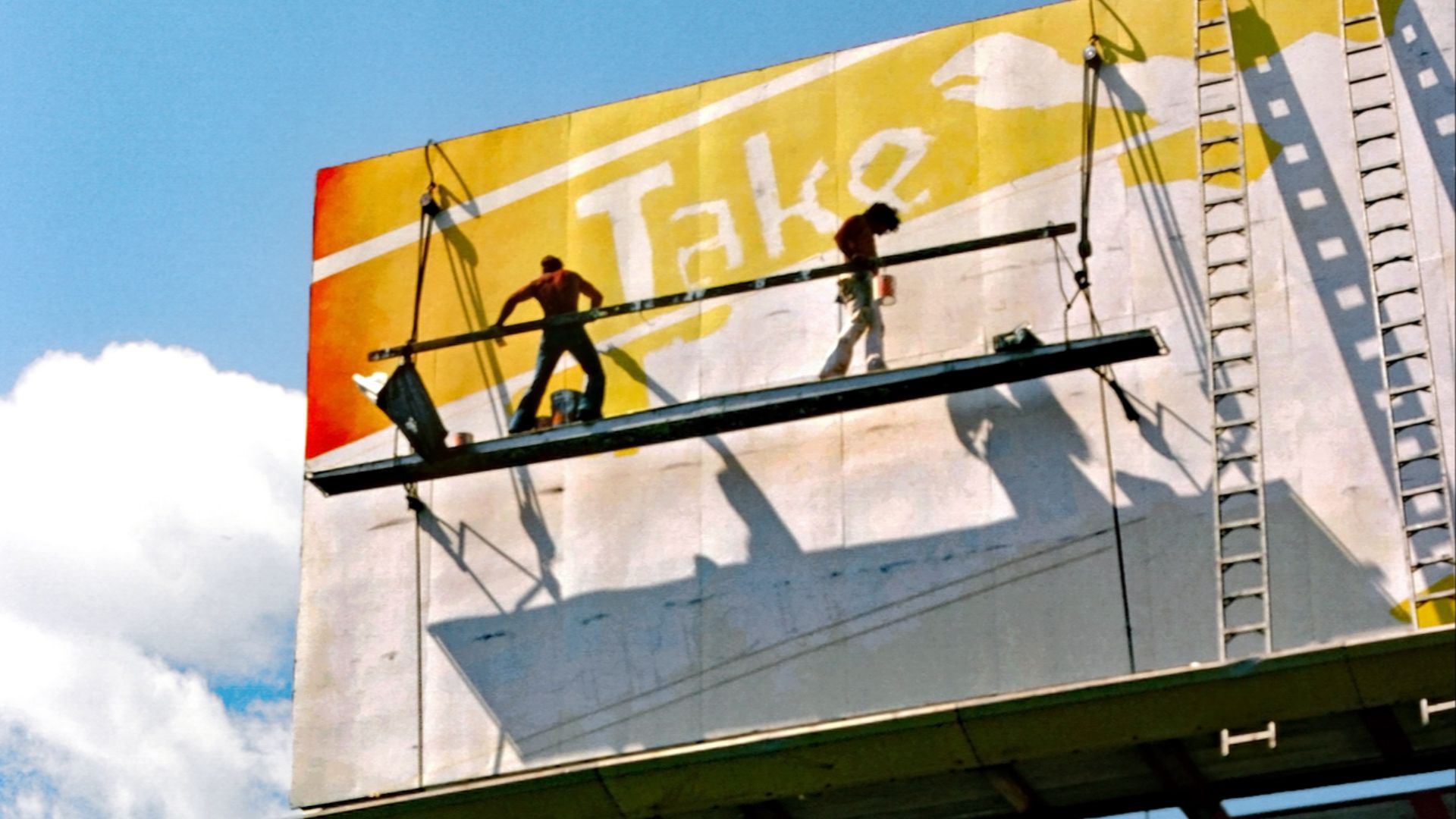 Billboard workers painting advertisement near the 405 and 110 freeways in Carson, California - USA.