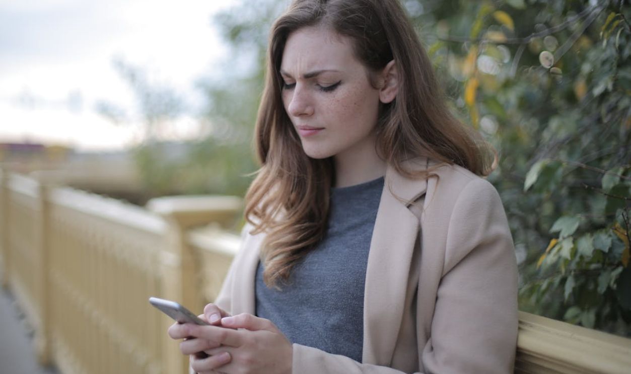 Pensive Woman in Using Smartphone