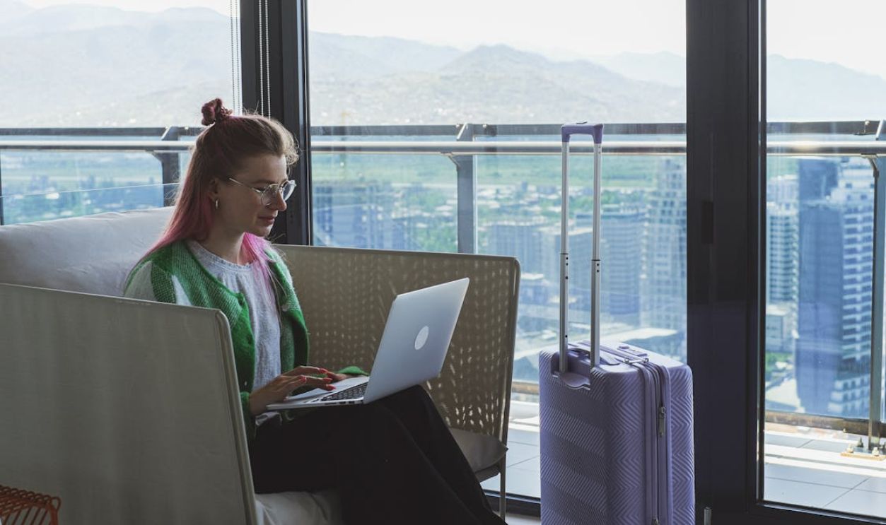 A Woman Sitting on the Sofa Using a Laptop