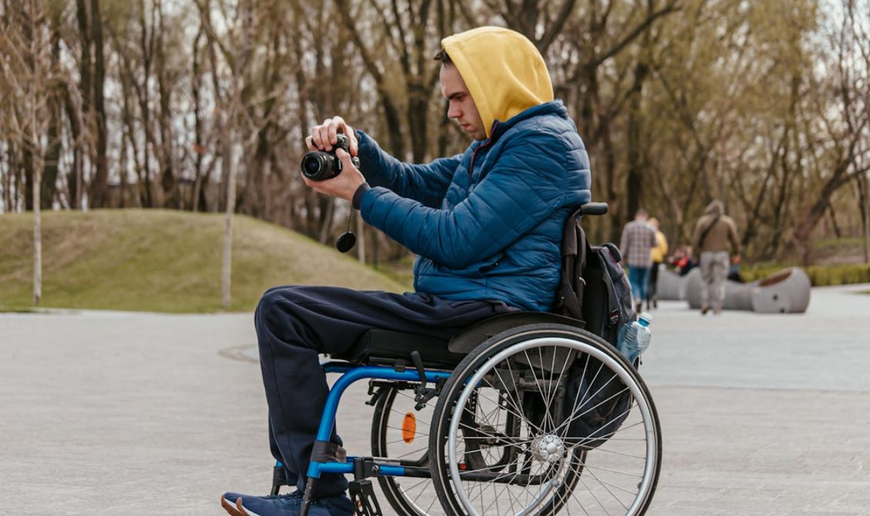 A Man Taking a Picture while on a Wheelchair