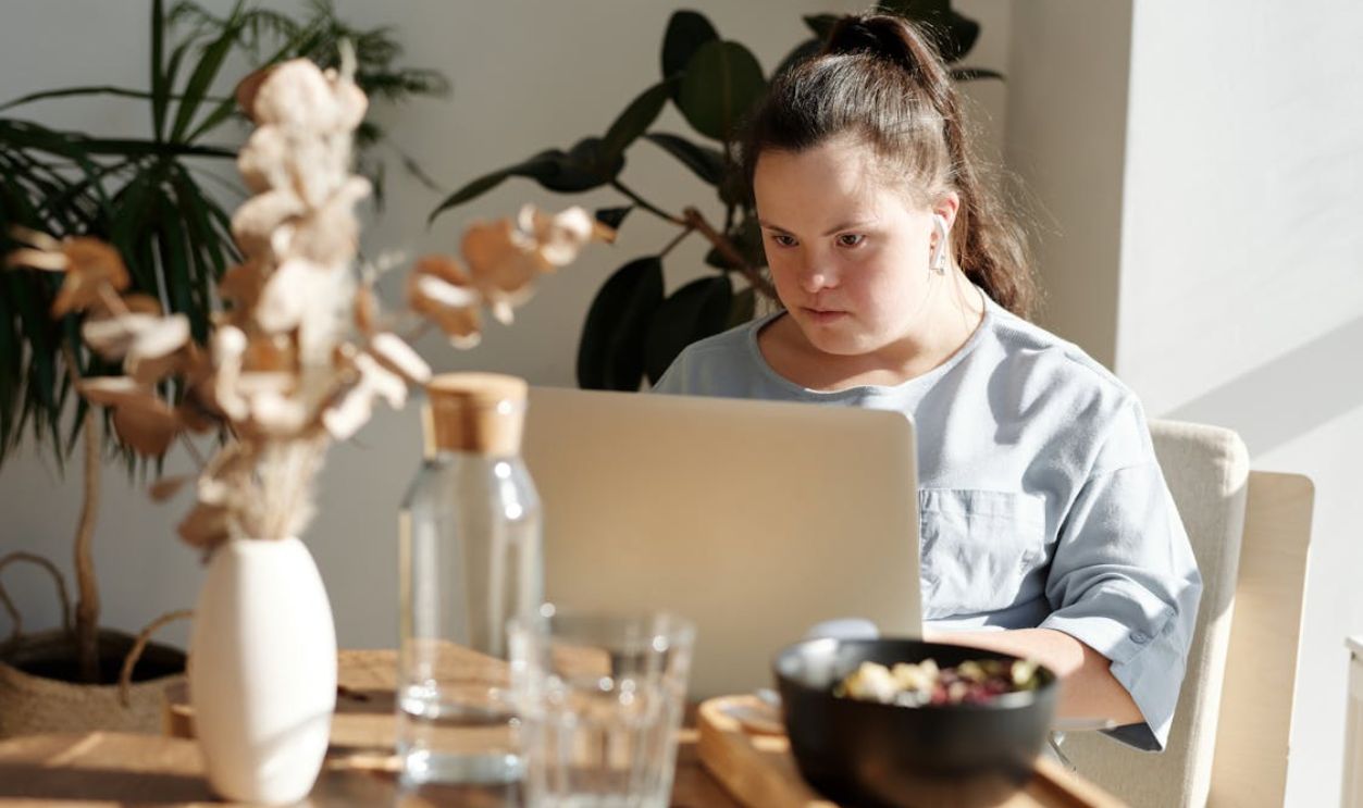 Young Girl Using Laptop Inside A Restaurant