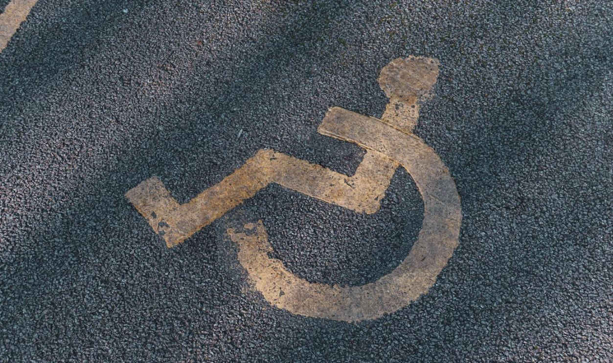 An International Access Symbol on Asphalt Road in Close-up Shot