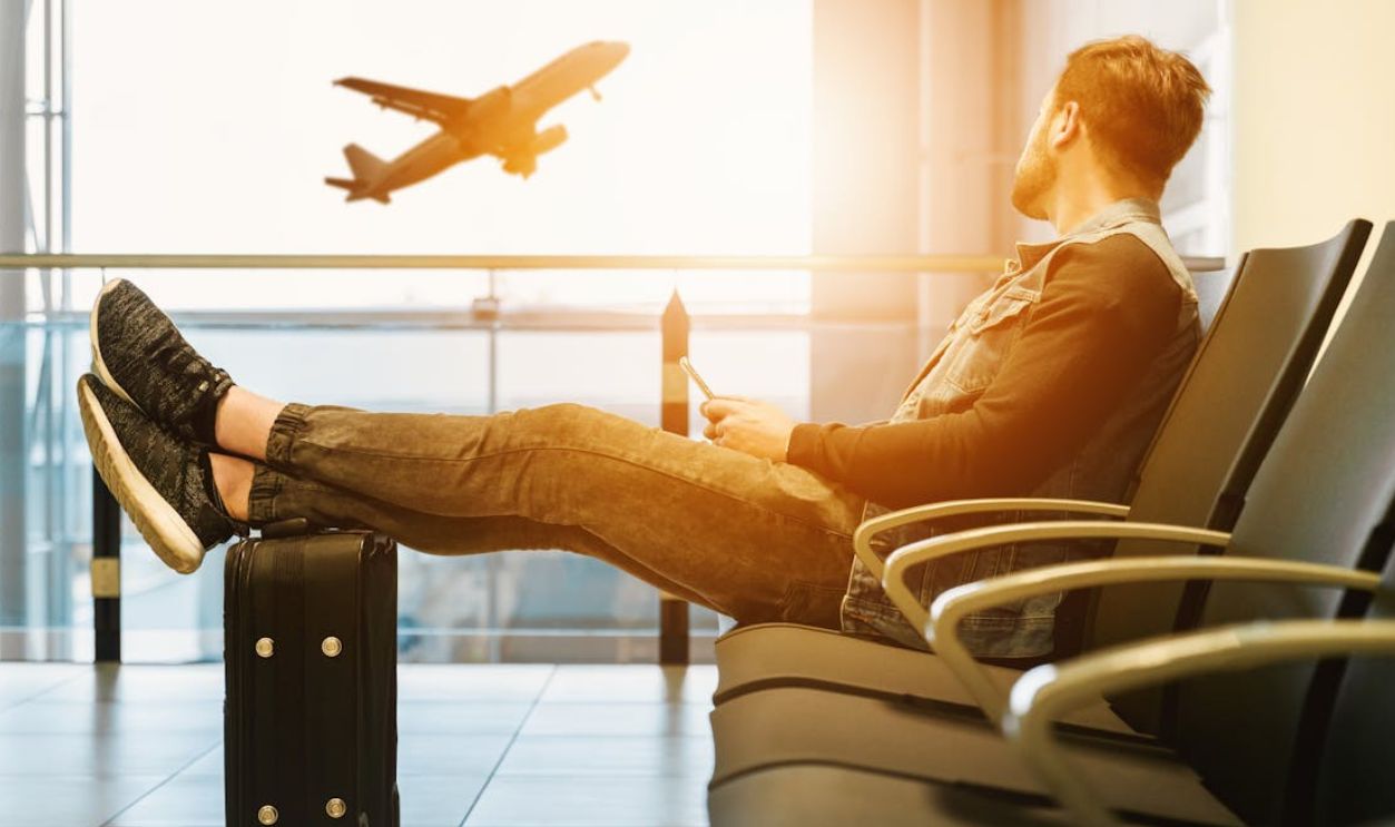 Man in airport waiting for boarding on plane