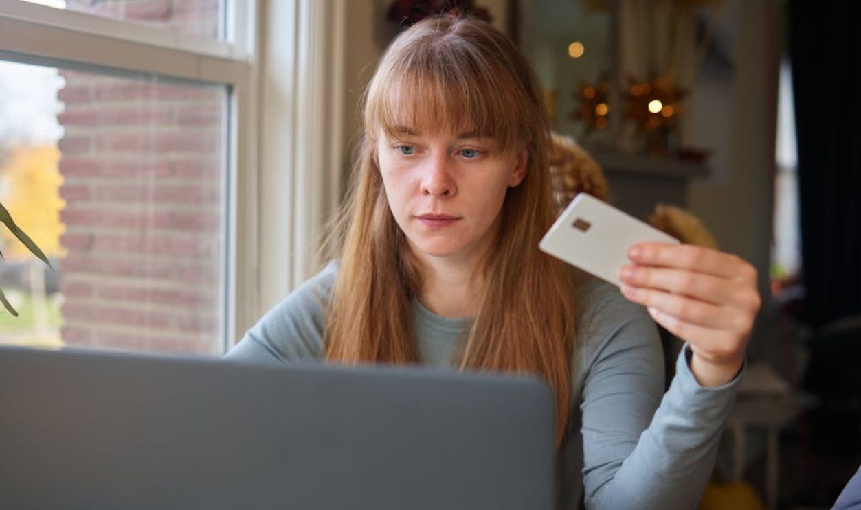 A Woman in Gray Long Sleeve Shirt Looking at the Laptop