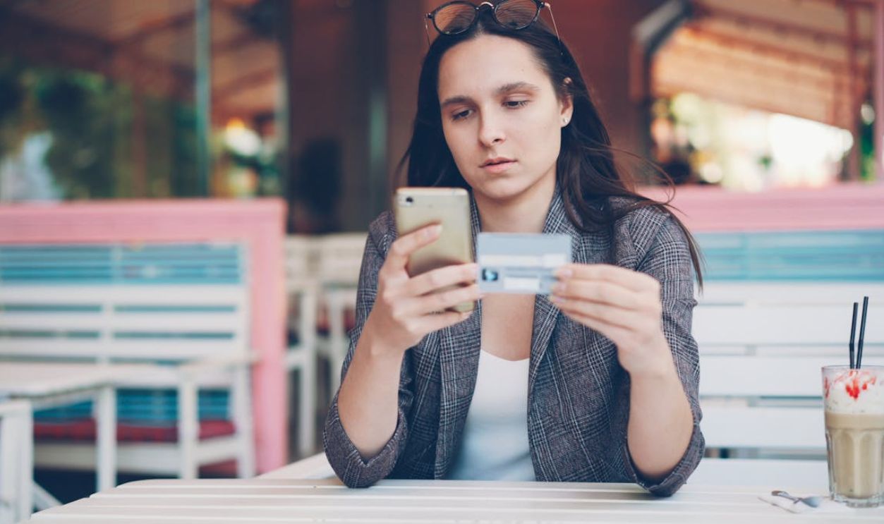 Woman Shopping Online with Credit Card and Phone