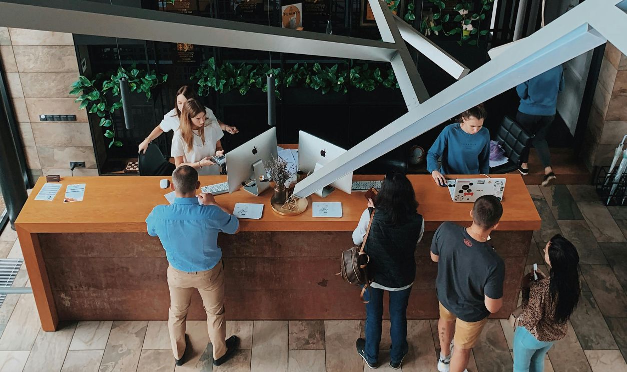 High Angle View on People at the Reception Desk in a Hotel