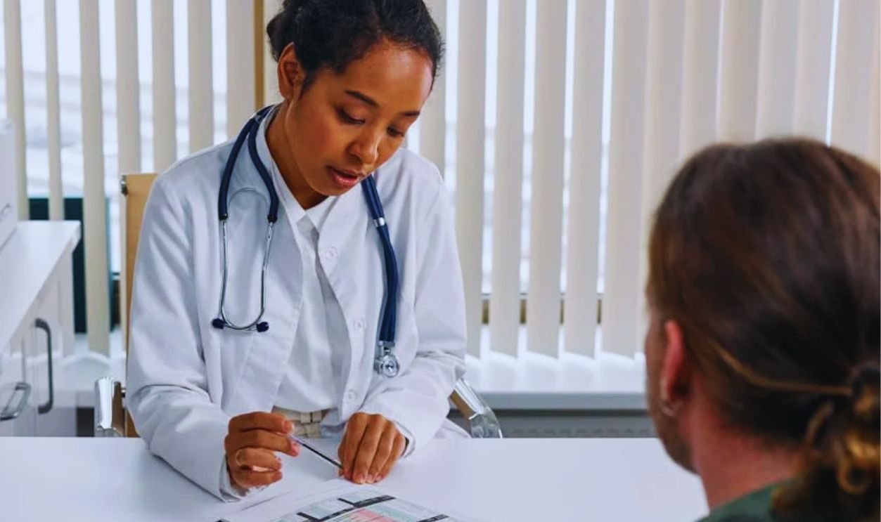 Man in White Dress Shirt Sitting at the Table