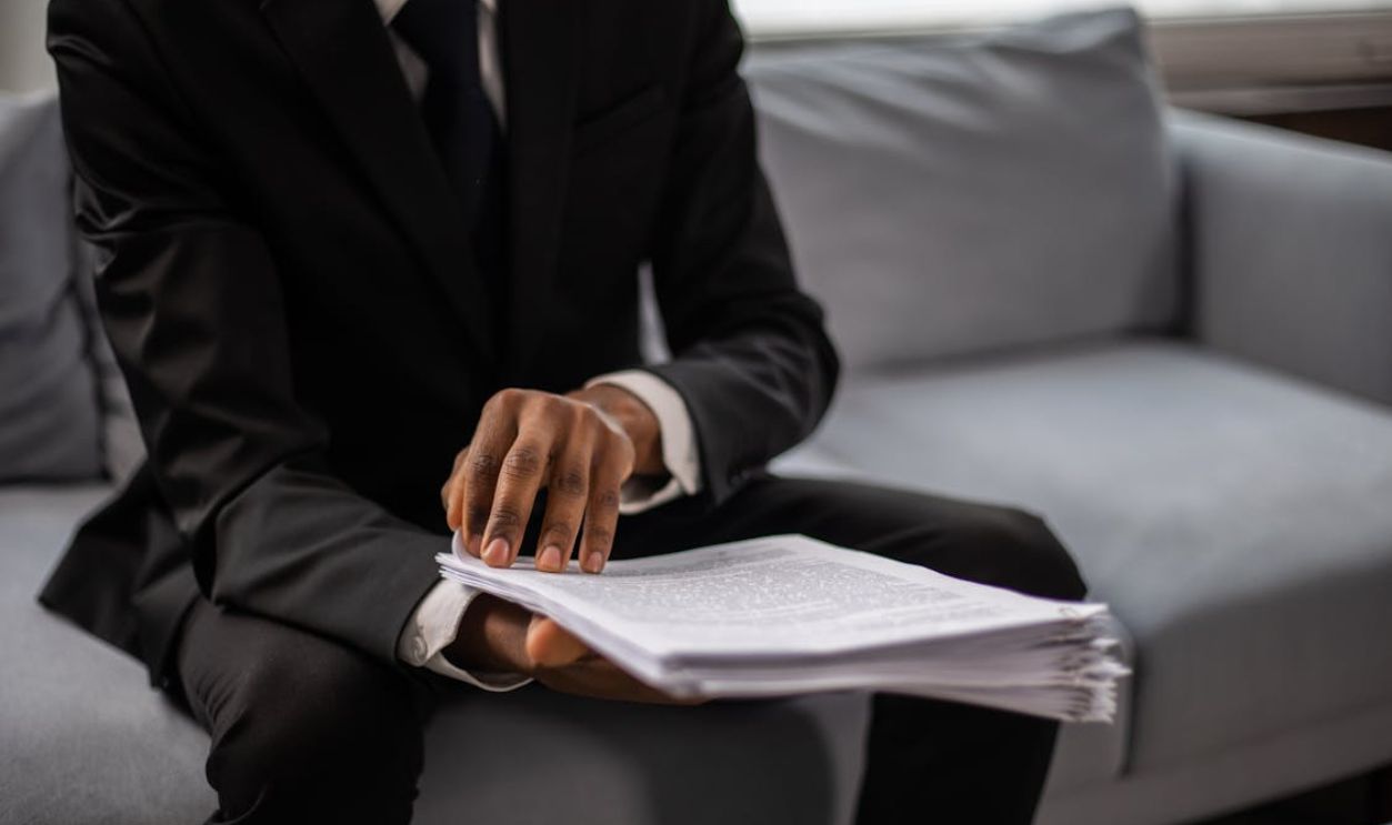 A Close-Up Shot of a Man Holding a Document