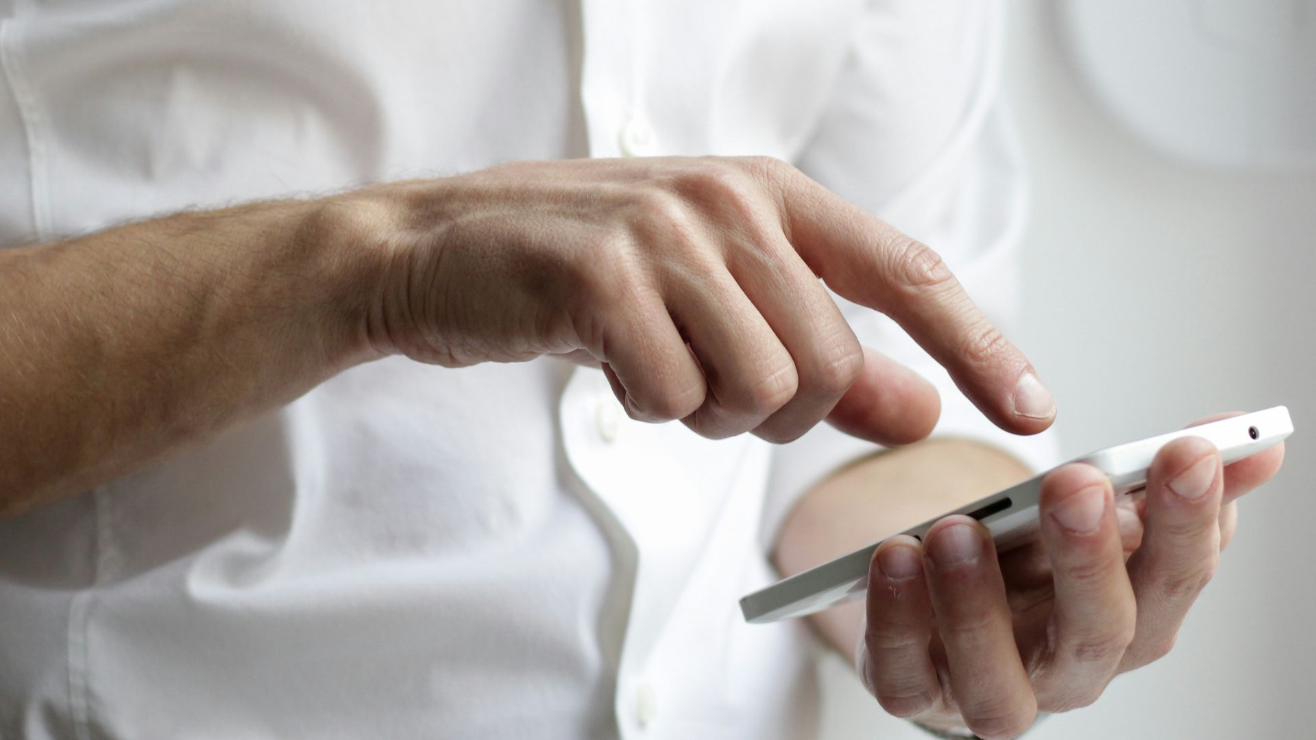 person holding white Android smartphone in white shirt