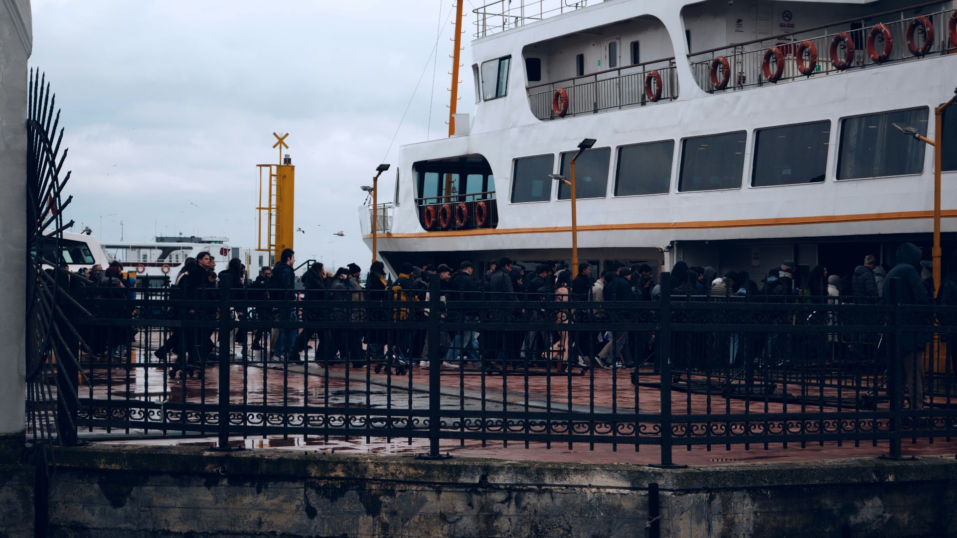 People waiting for a ferry on a cloudy day