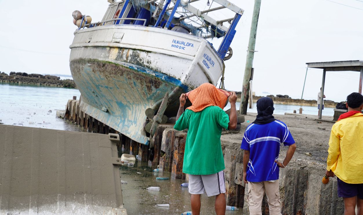This photo taken on January 16, 2022 shows a boat out of the water and on the dock from the tsunami at the harbour in Tonga's capital Nukualofa following the January 15 eruption of the nearby Hunga Tonga-Hunga Haapai underwater volcano.