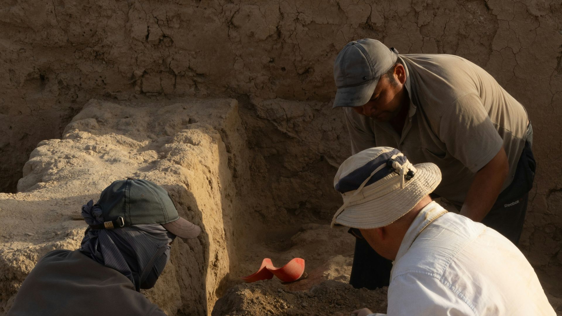 A group of men kneeling down next to each other