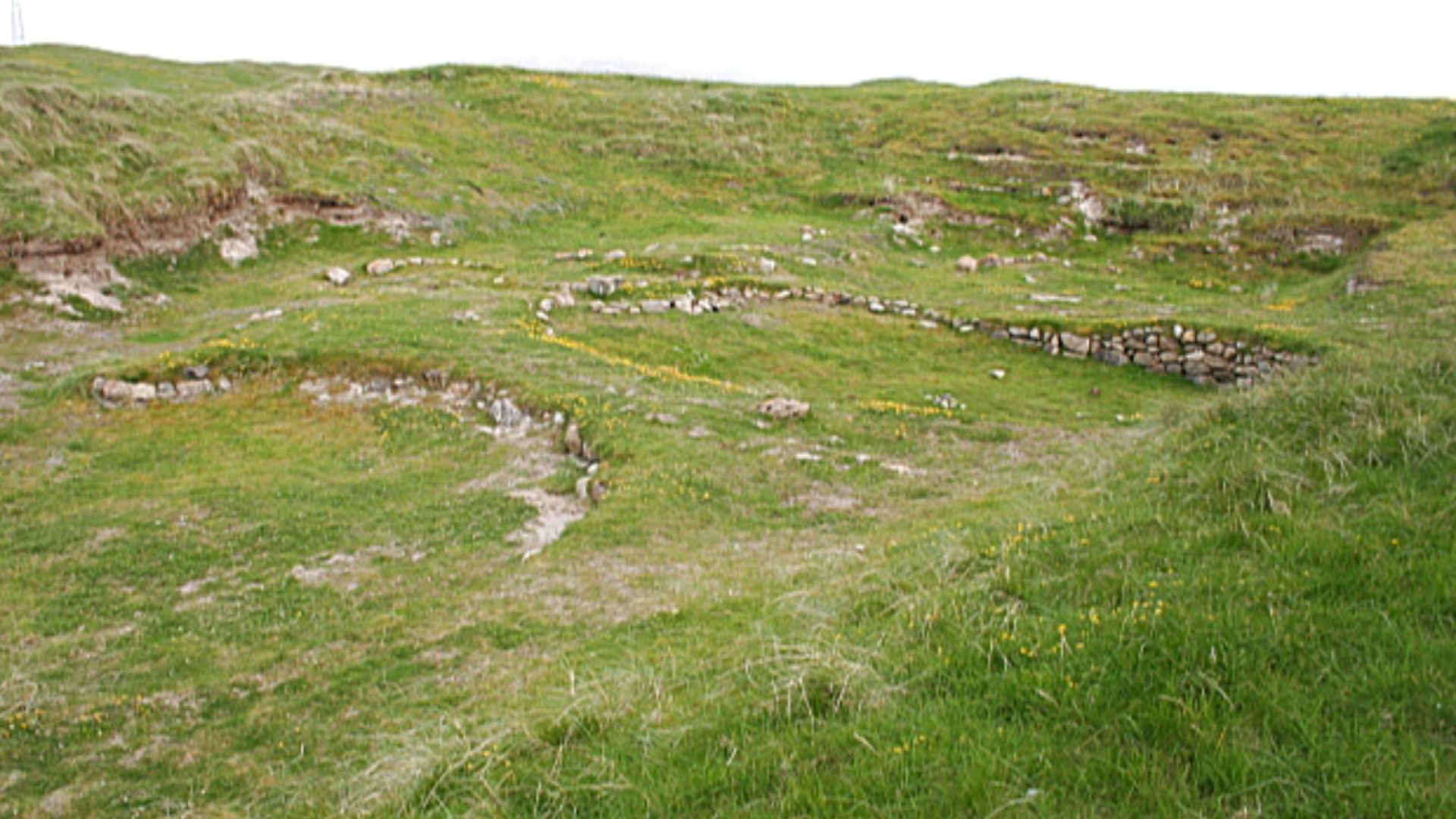 Bronze Age Settlement This is a small part of what was an extensive settlement dating back to around 2200 BC and occupied until at least 500 BC. The round houses were partially sunk into the ground, with low walls and roofs thatched with reeds. Changing c