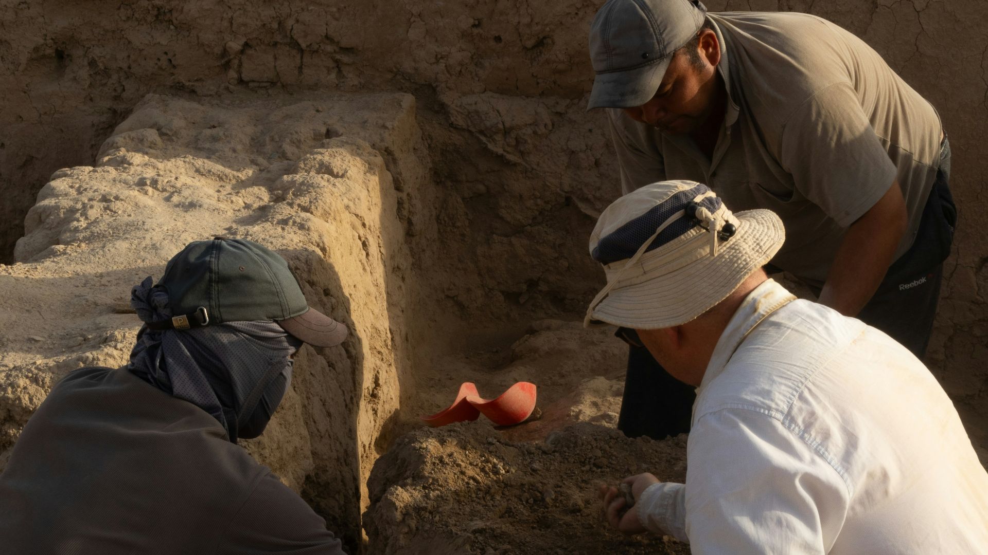 A group of men kneeling down next to each other