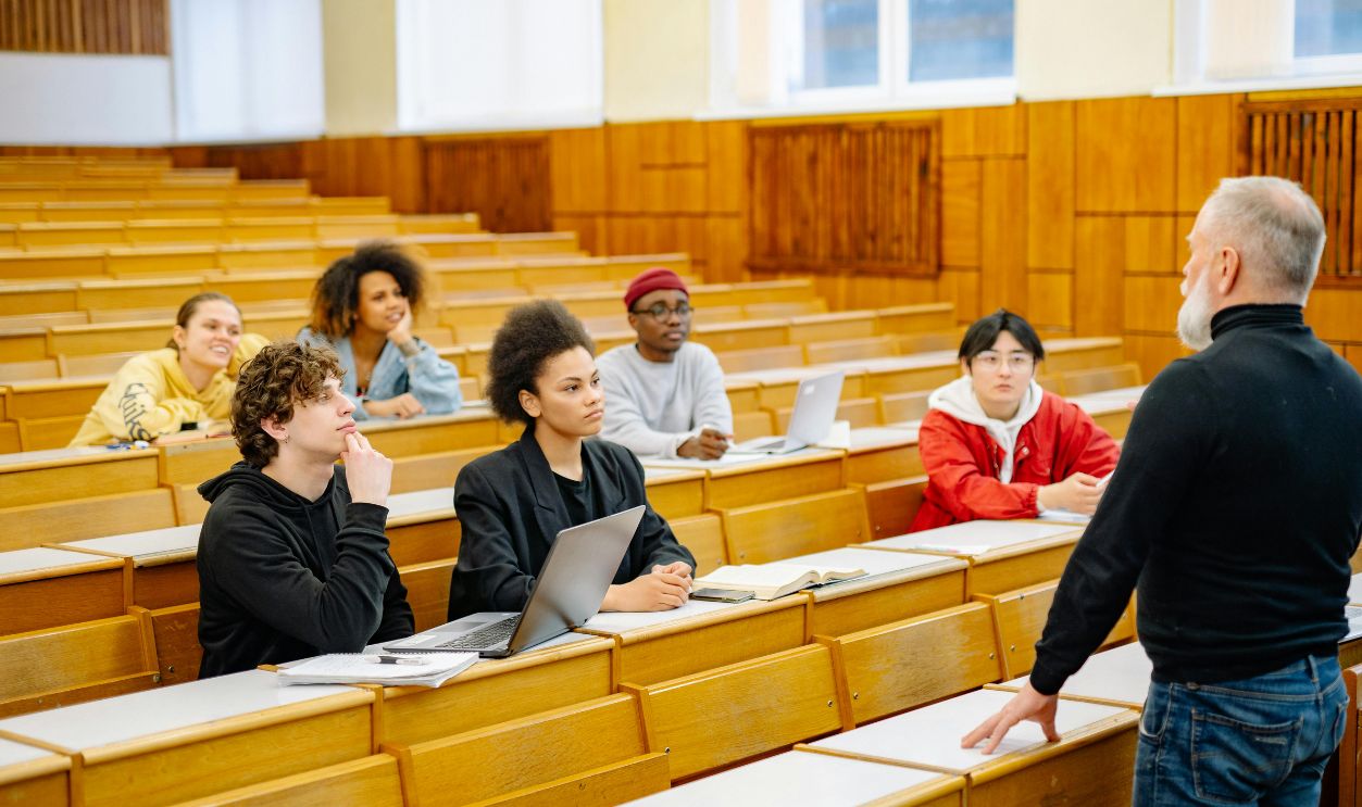 University students engaging in a diverse classroom setting with a lecturer.