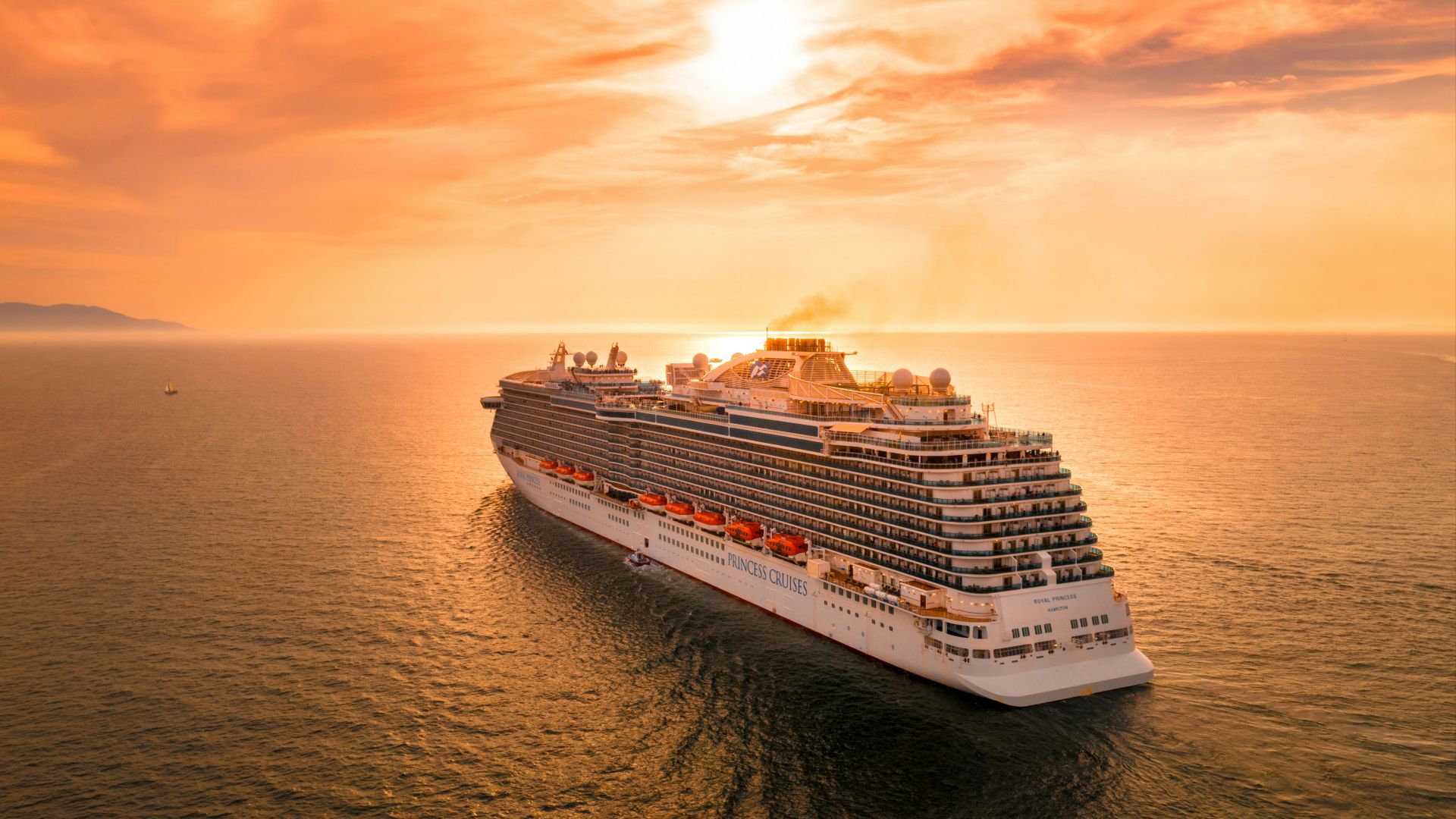 white ship on sea during sunset