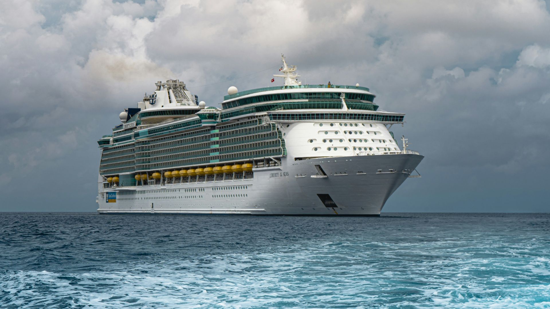 white cruise ship on sea under white clouds and blue sky during daytime