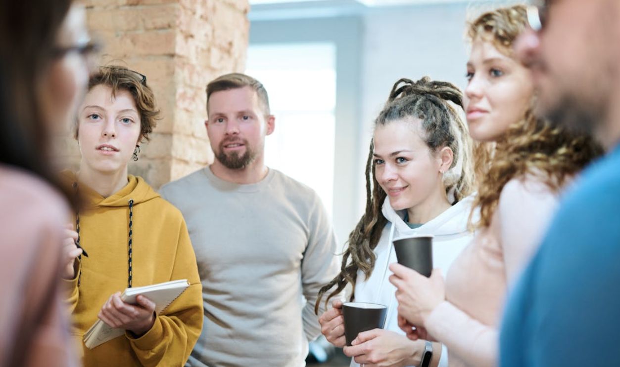 Diverse team engaged in a collaborative meeting in a contemporary office setting with natural lighting