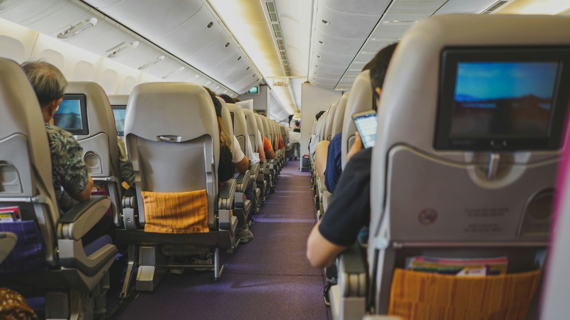 people sitting on chairs inside airplane