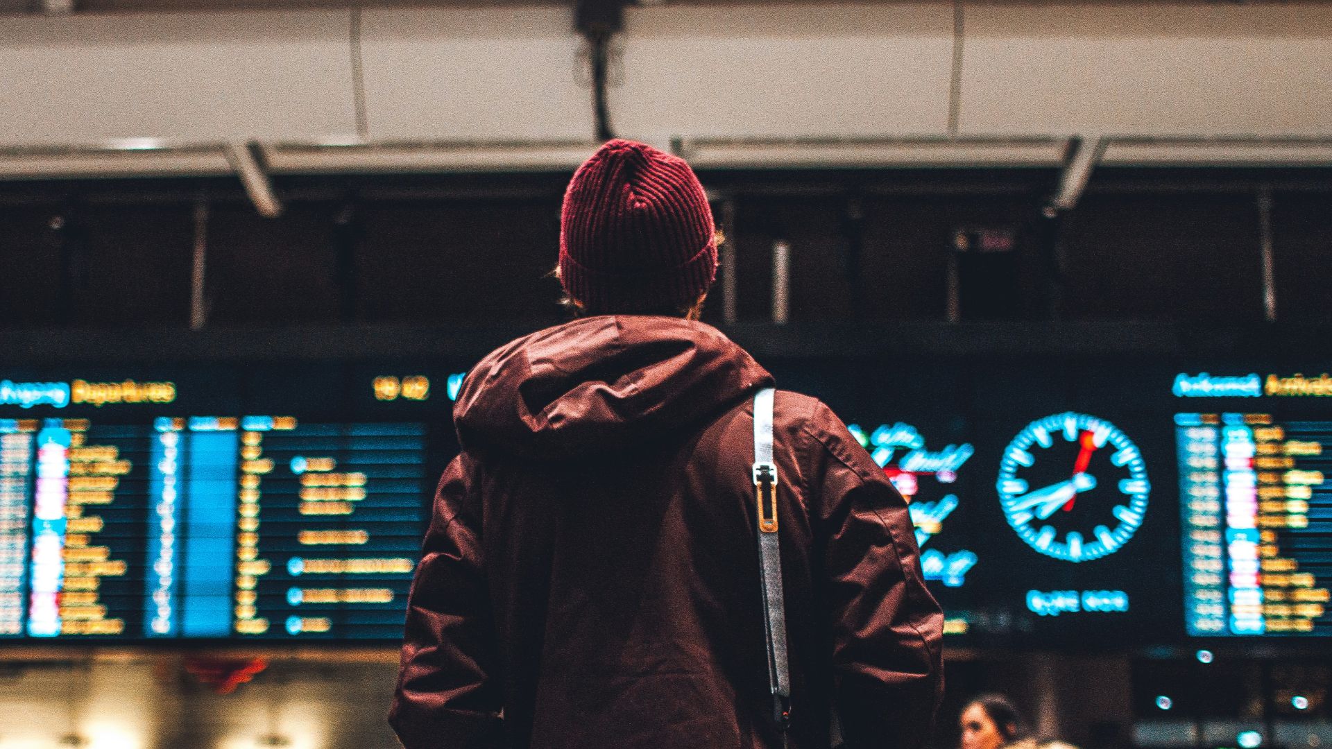 person looking up to the flight schedules