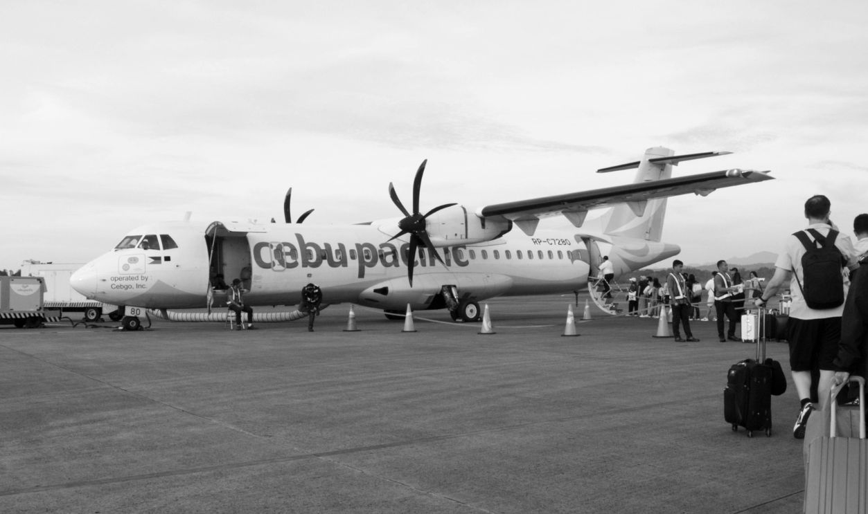 Cebu Pacific airplane at the airport with passengers boarding for departure