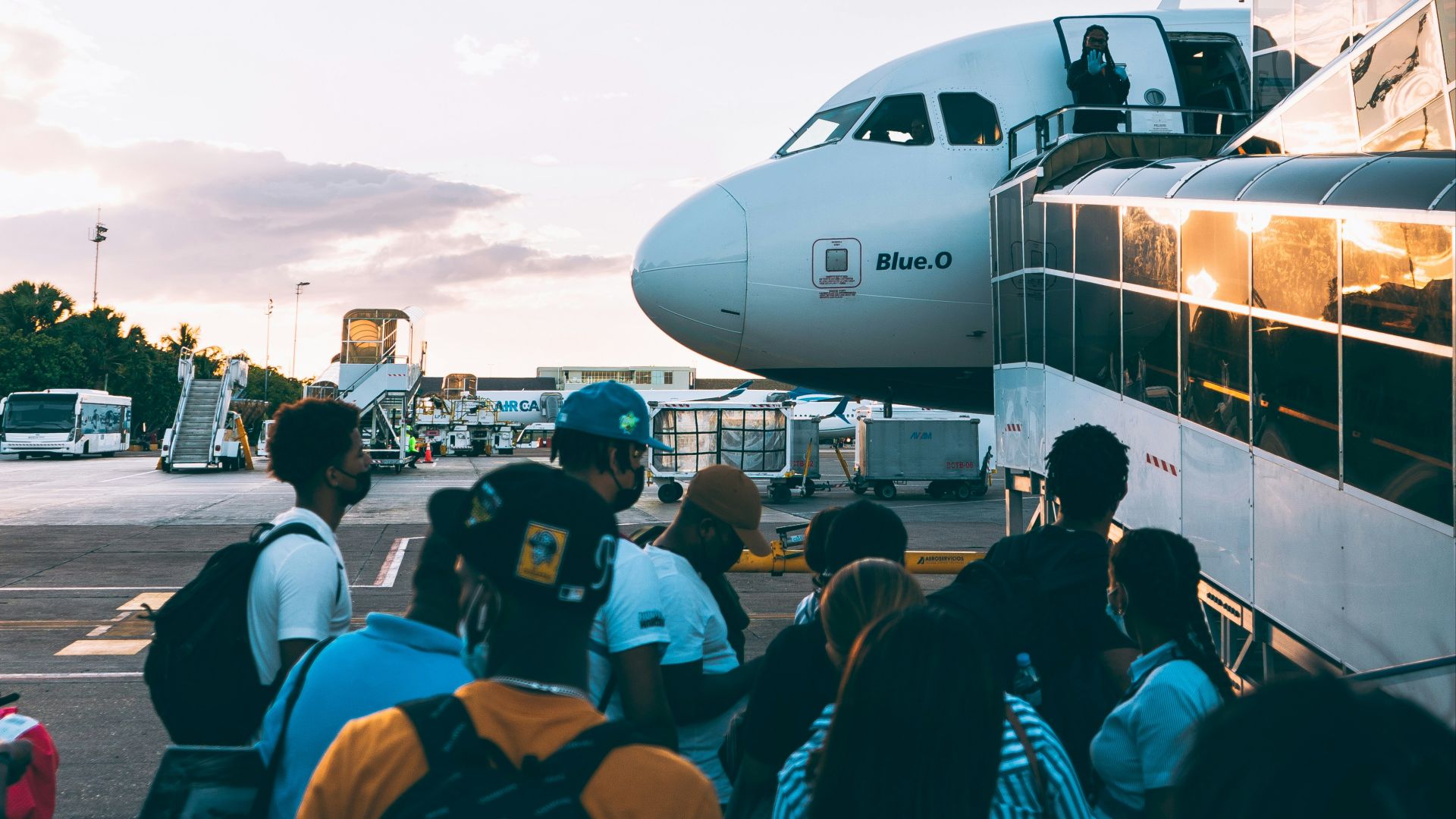 a group of people standing in front of an airplane
