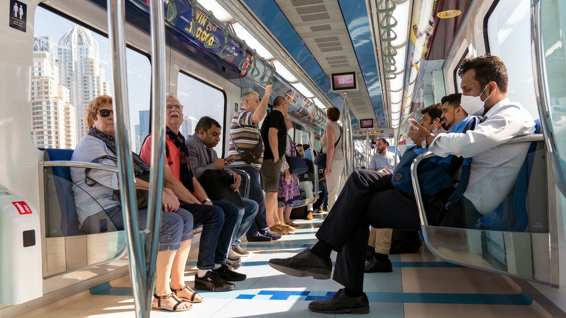 people sitting on blue and white train seat