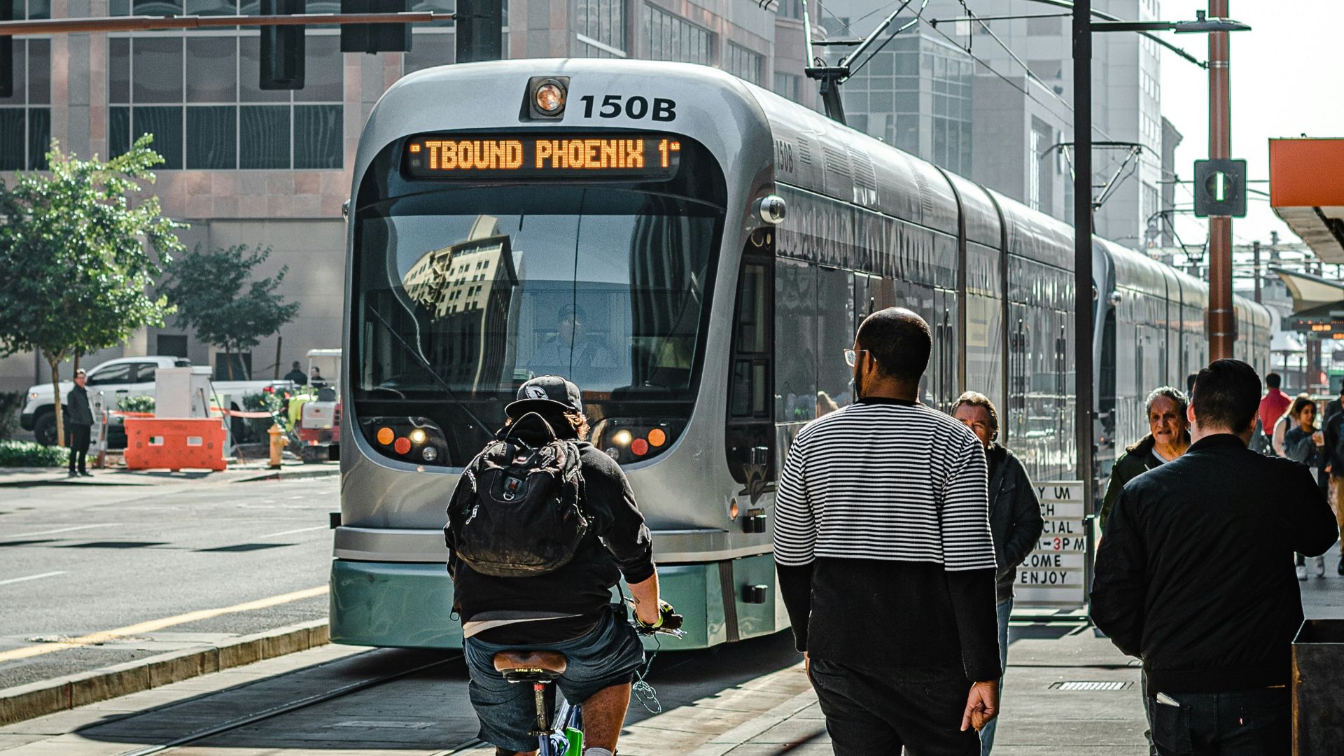 people walking on pedestrian lane near white and red train during daytime