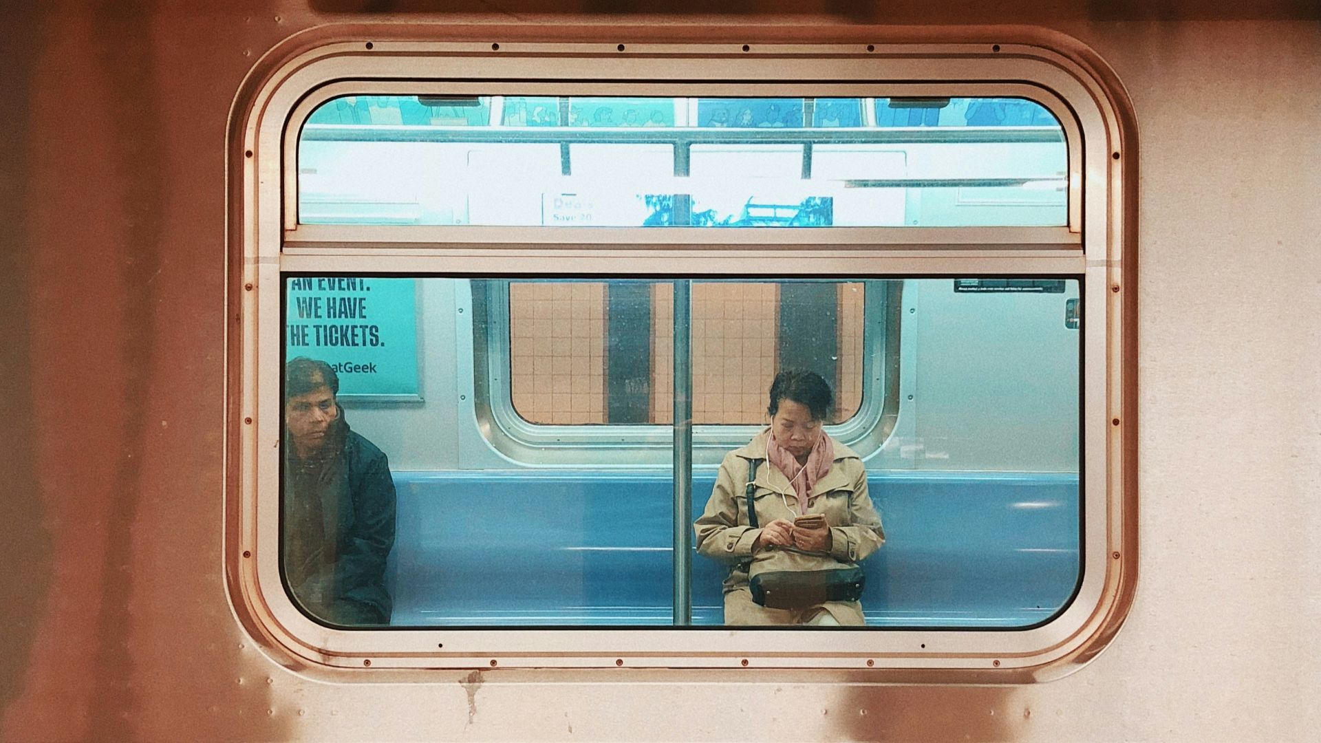 man in blue denim jeans sitting on train