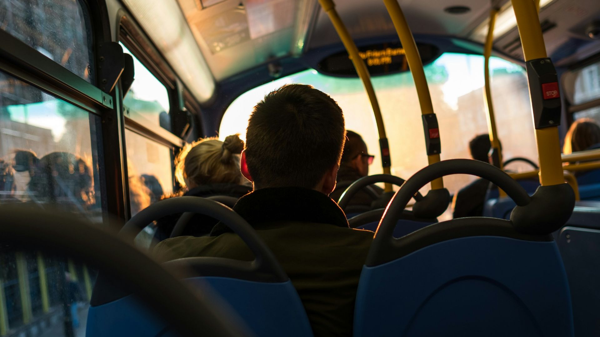 photo of man sitting inside bus