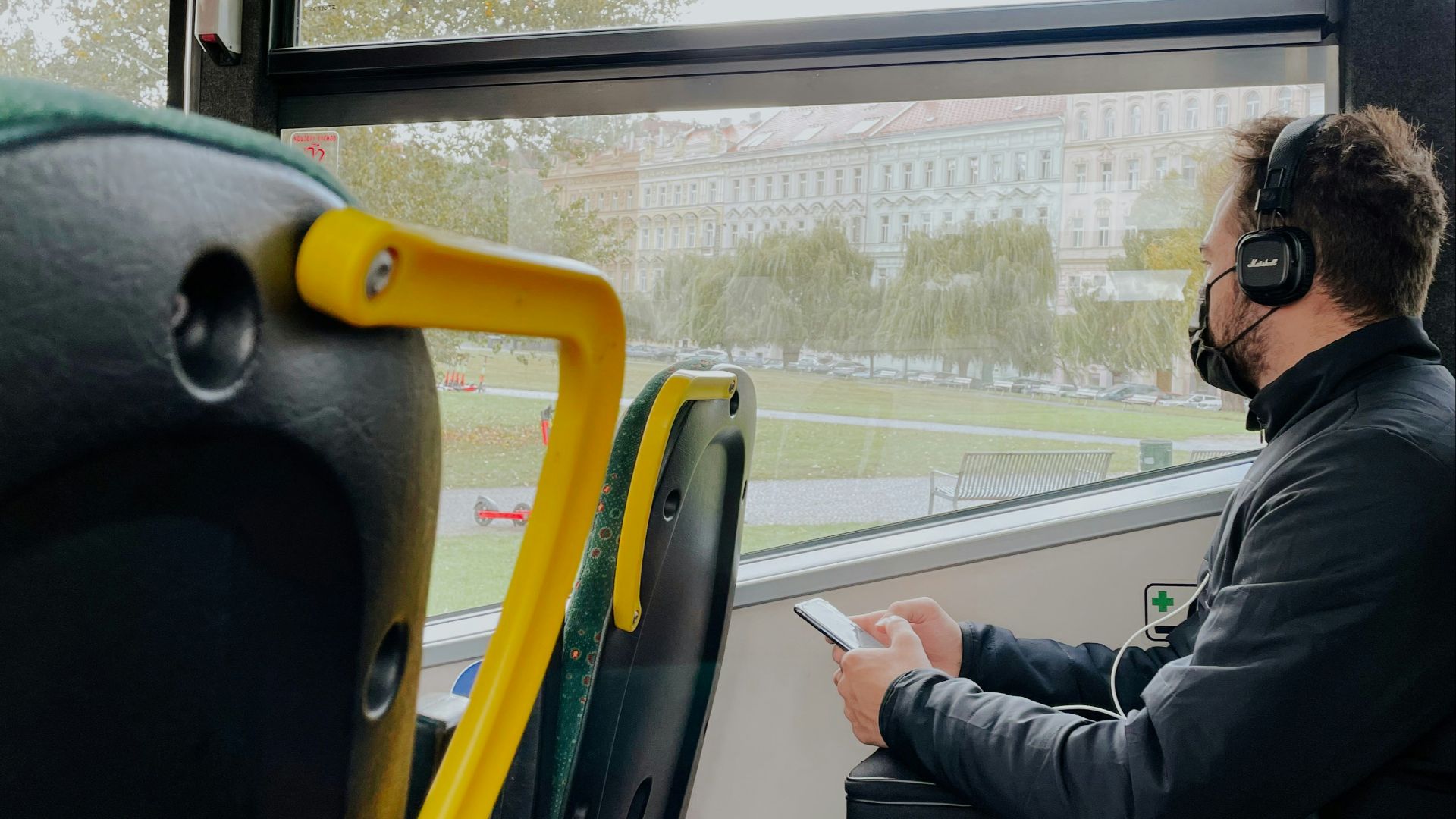 a man wearing headphones sitting on a bus