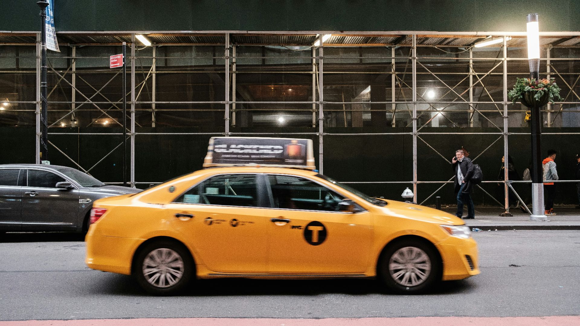 yellow taxi cab in front of the building