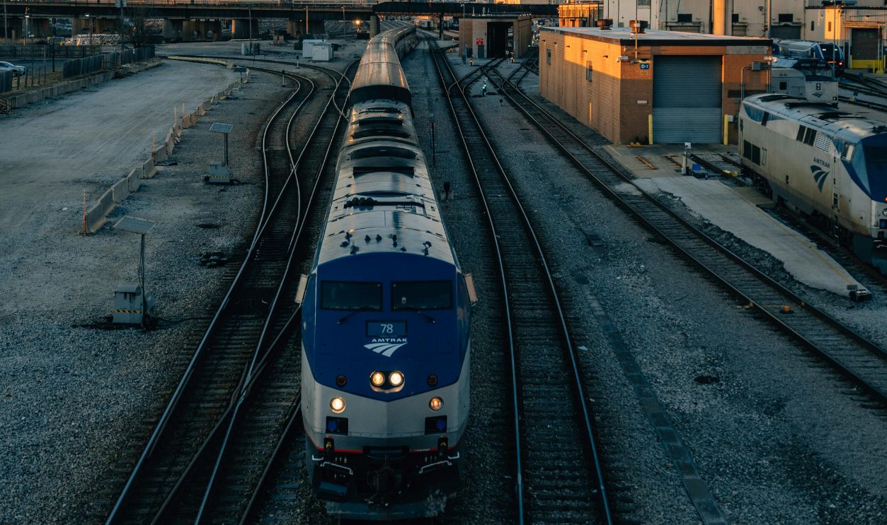 A train approaches the Chicago skyline at sunset, capturing the vibrant city's transport network