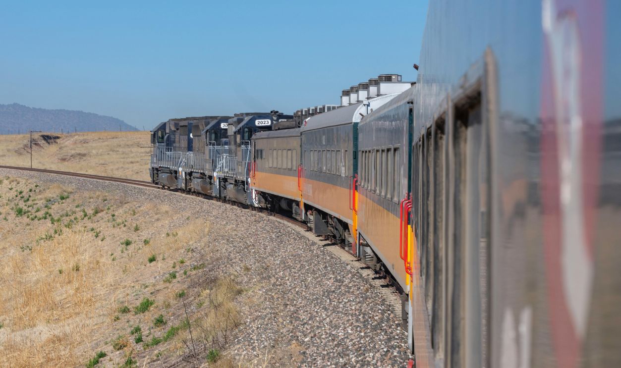 A picturesque train ride through Chihuahua, capturing the vast landscape and railway tracks