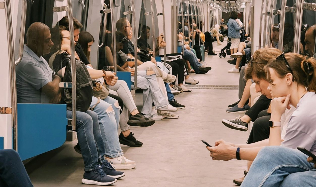 Passengers seated inside a modern subway car