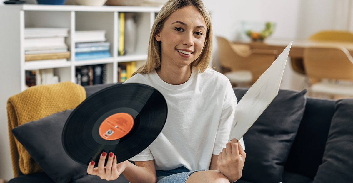 Blonde girl holding a vinyl record.