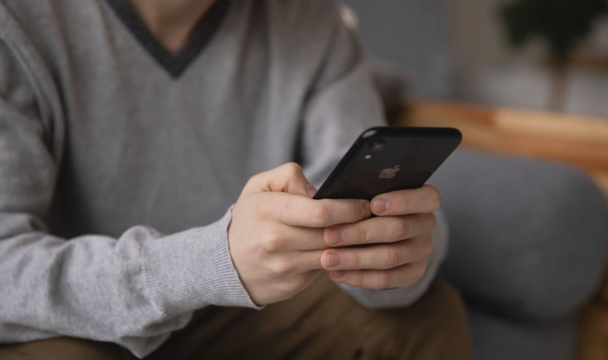 Person holding a smartphone, focusing on connectivity and modern technology