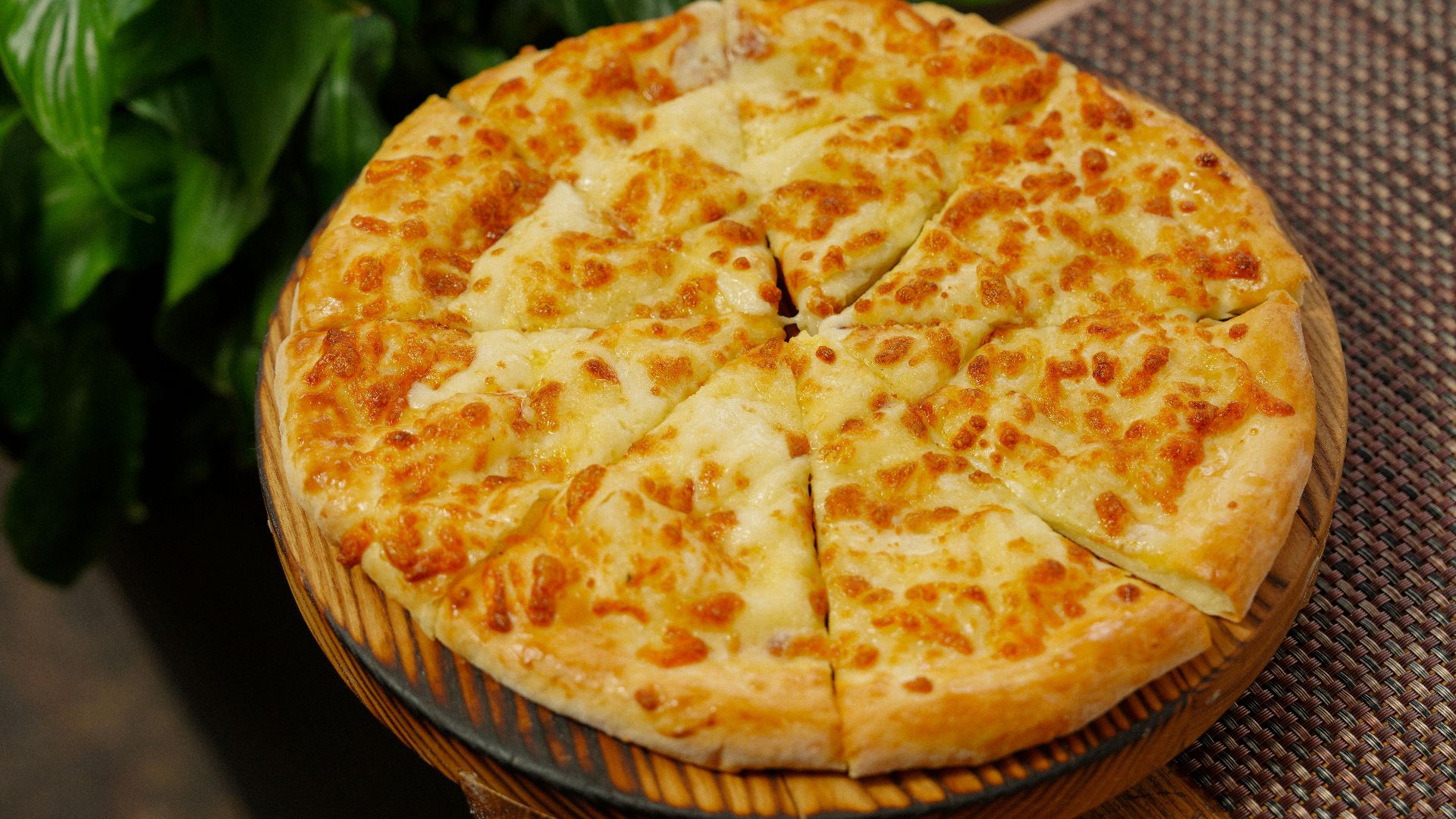 A delicious cheese pizza on a wooden board, perfect for dinner or a casual meal.
