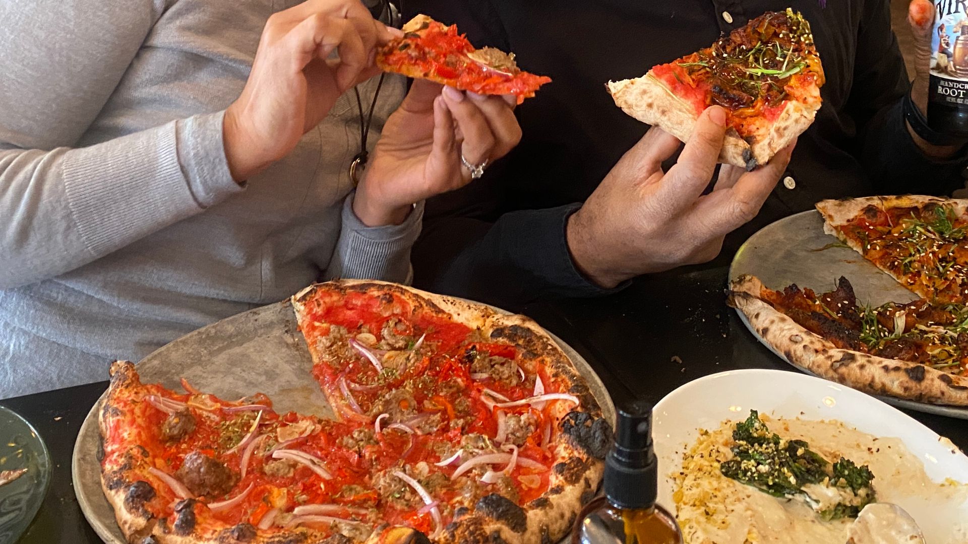 Carla Vernón and her brother, Antonio Vernón, enjoying Pizzeria Lola