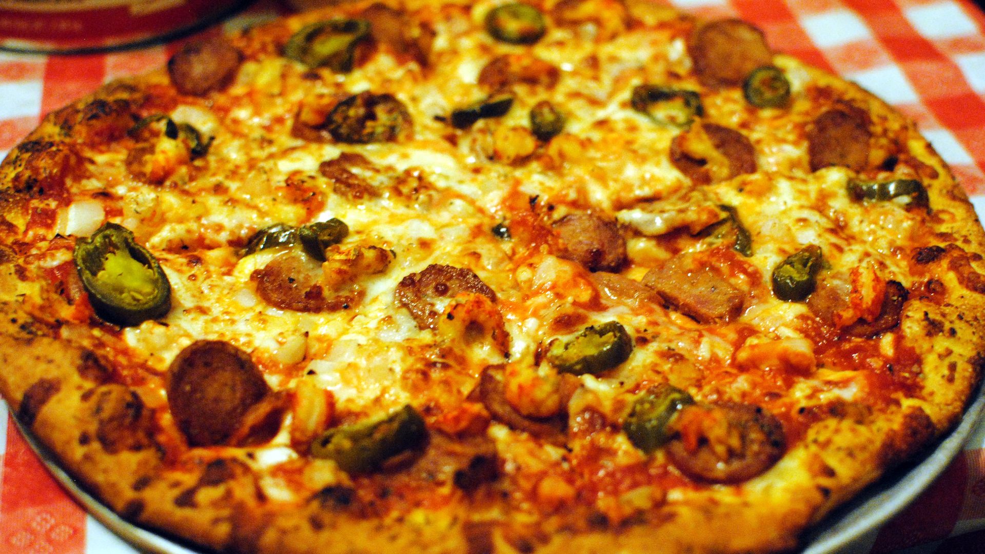 A creamy homemade cajun sauce tops your favorite pizza dough, then gets piled with sliced andouille sausage, bell peppers, and gooey cheese.