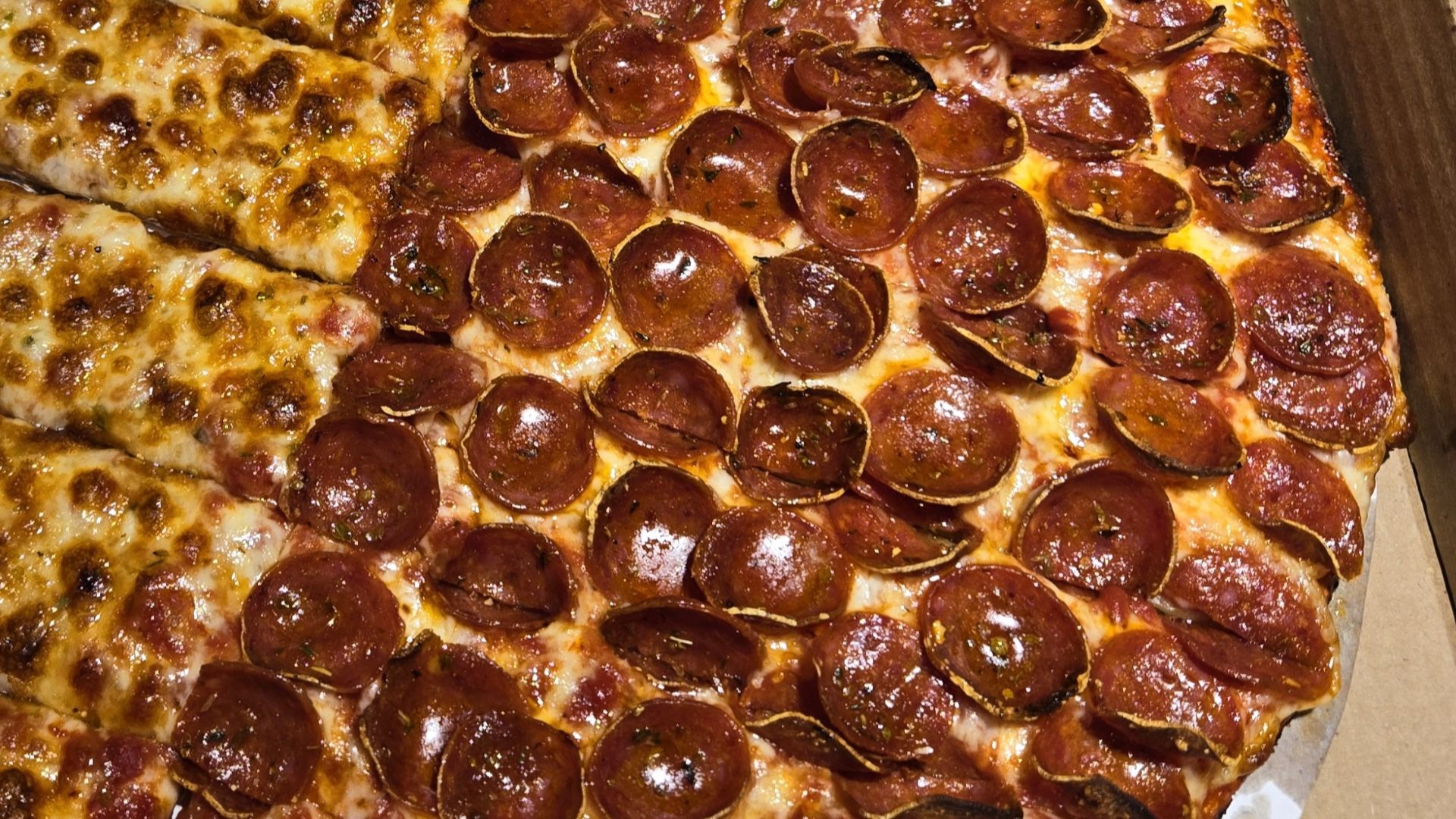 A half cheese, half pepperoni pizza from Massey's Pizza in Westerville, Ohio, cut into long rectangles