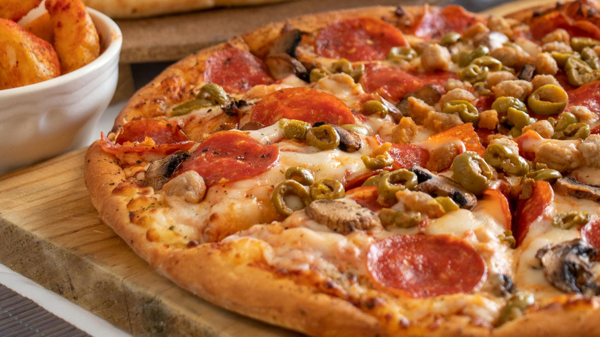Close-up of pepperoni and veggie pizzas with soda, perfect for a casual dining experience.