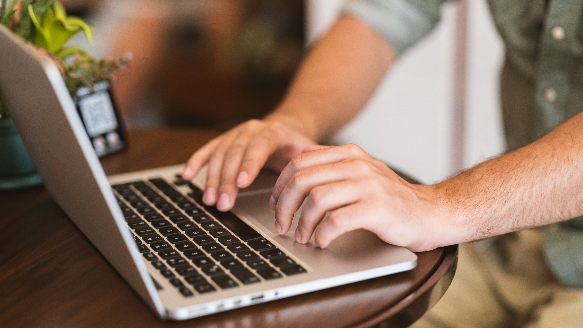 a man typing on a laptop