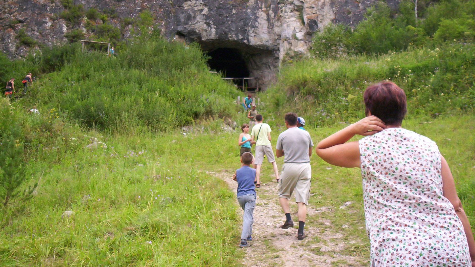 Tourists at the entrance to Denisova Cave, Russia