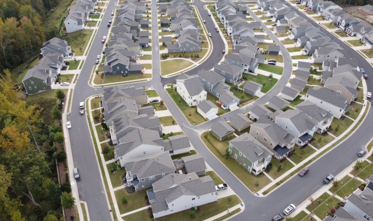 Drone shot of a modern residential area with houses and winding roads in Fort Mill, SC